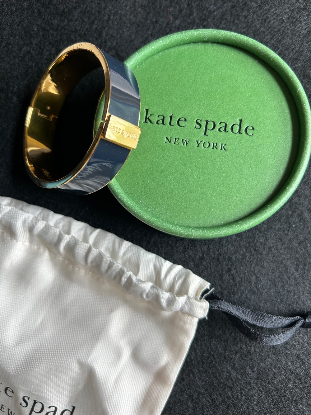Kate Spade idiom black enamel and gold-tone hinged bangle. “Make Waves”
